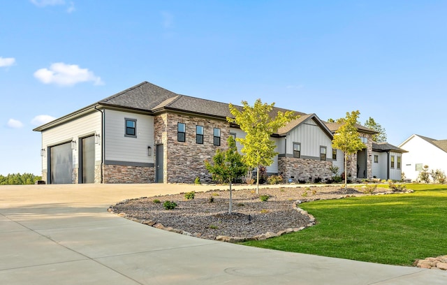 view of front of property with a front lawn and a garage