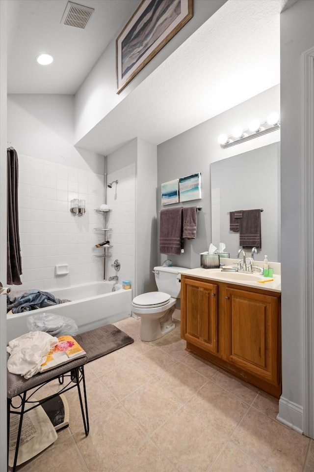 full bathroom with toilet, vanity, tile patterned floors, and tiled shower / bath