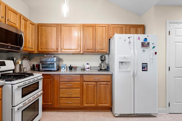 kitchen with white appliances and vaulted ceiling