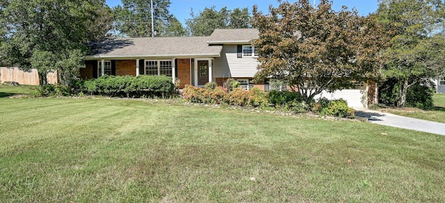 split level home with a garage and a front lawn