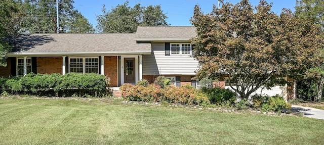 tri-level home with a front yard