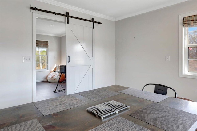 unfurnished dining area featuring plenty of natural light, ornamental molding, and a barn door