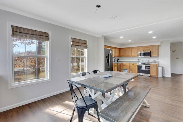 dining area featuring crown molding and dark hardwood / wood-style floors