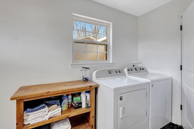 clothes washing area with washing machine and dryer