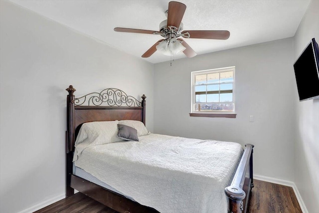 bedroom with ceiling fan and dark hardwood / wood-style flooring