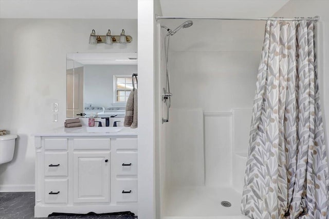 bathroom featuring vanity and curtained shower