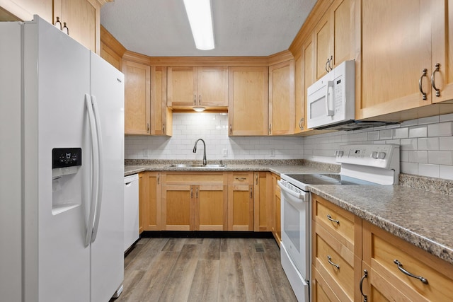 kitchen featuring white appliances, light wood-type flooring, a textured ceiling, sink, and backsplash