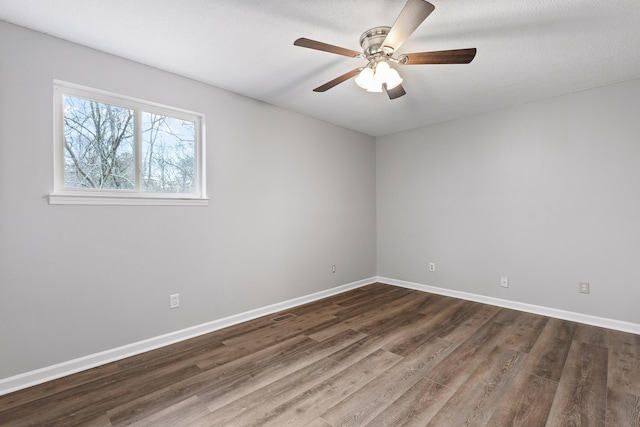 unfurnished room with dark wood-type flooring, a textured ceiling, and ceiling fan