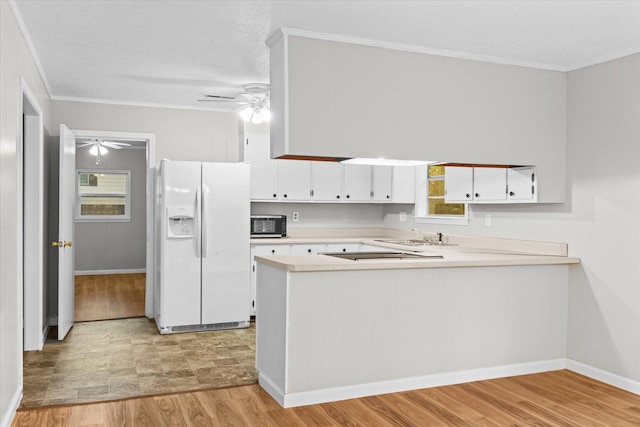 kitchen featuring white refrigerator with ice dispenser, kitchen peninsula, crown molding, white cabinets, and light wood-type flooring