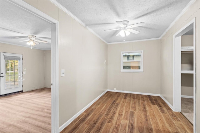 spare room with crown molding, ceiling fan, a textured ceiling, and hardwood / wood-style flooring