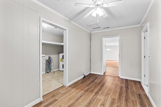 interior space featuring ceiling fan, electric water heater, hardwood / wood-style floors, a textured ceiling, and ornamental molding