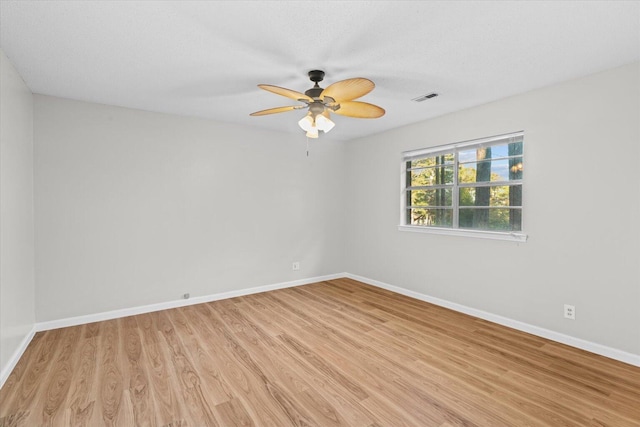 empty room featuring ceiling fan and light wood-type flooring