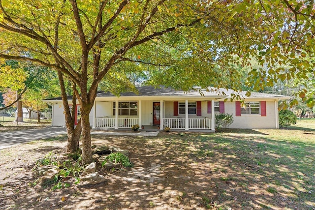 ranch-style house with a porch and a garage