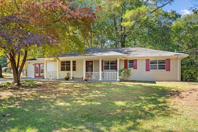 ranch-style home featuring french doors, a front lawn, and a porch