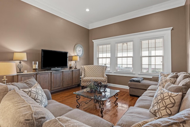 living room featuring a healthy amount of sunlight, light hardwood / wood-style floors, and ornamental molding