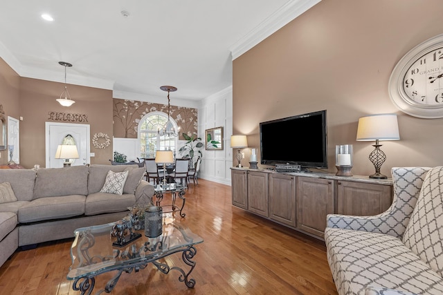 living room with light hardwood / wood-style floors and crown molding