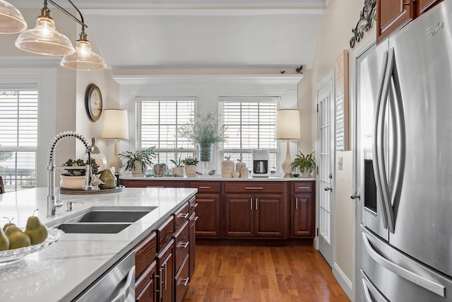 kitchen featuring decorative light fixtures, a healthy amount of sunlight, sink, and stainless steel appliances