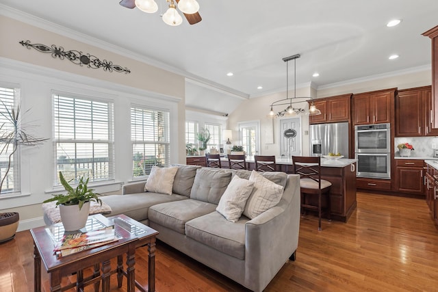 living room featuring crown molding, dark hardwood / wood-style flooring, and ceiling fan with notable chandelier