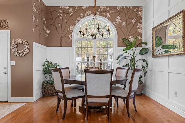 dining space with a chandelier and wood-type flooring