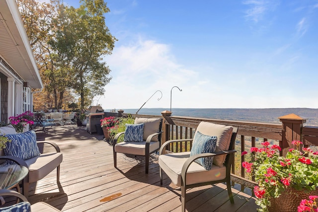 wooden terrace featuring a water view