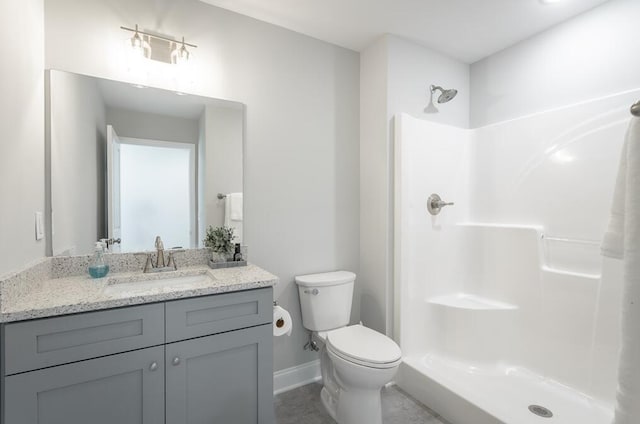 bathroom with vanity, toilet, and a shower