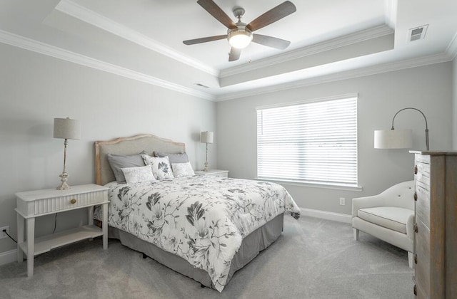 carpeted bedroom featuring a raised ceiling, ceiling fan, and crown molding