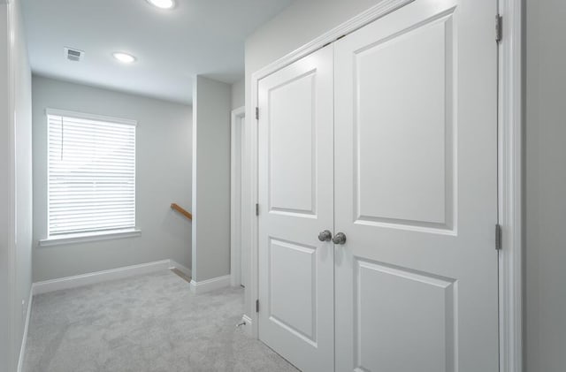 hallway featuring light carpet