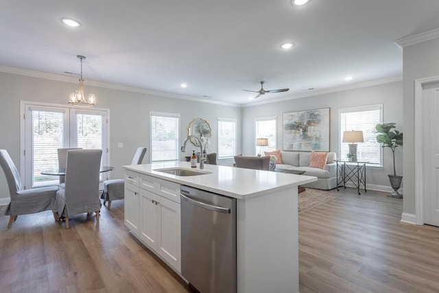 kitchen featuring dishwasher, sink, hanging light fixtures, a center island with sink, and white cabinets