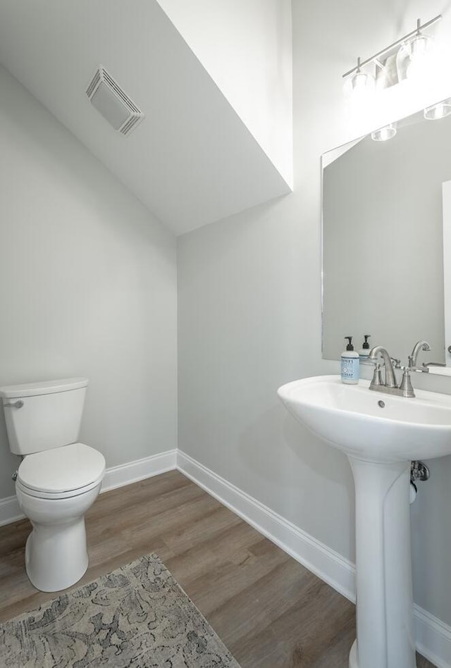 bathroom featuring sink, hardwood / wood-style floors, and toilet