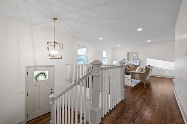 staircase featuring a notable chandelier and hardwood / wood-style flooring