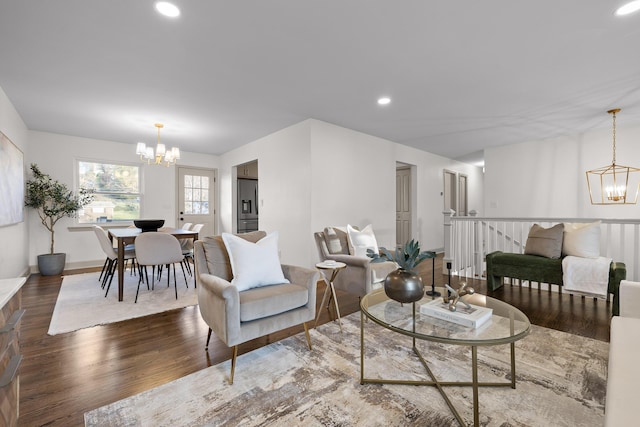 living room with wood-type flooring and a chandelier