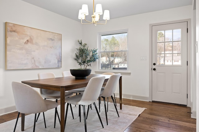 dining space featuring dark hardwood / wood-style floors, a chandelier, and plenty of natural light