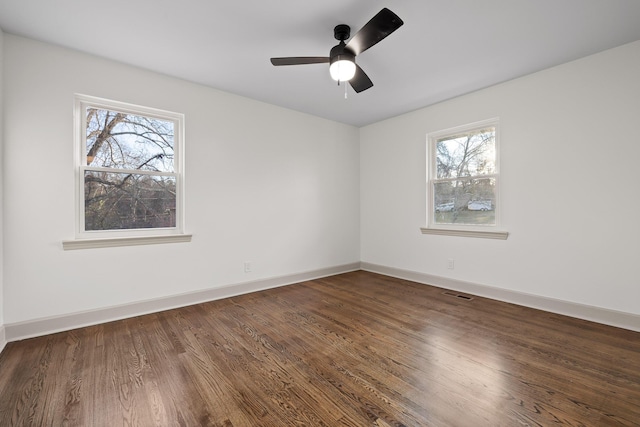 unfurnished room featuring ceiling fan and dark wood-type flooring