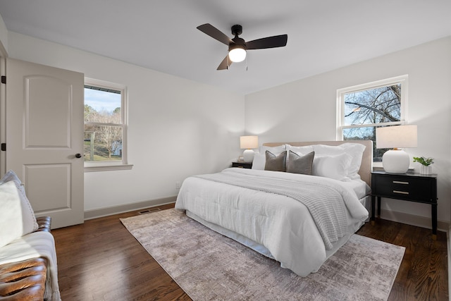 bedroom with ceiling fan and dark hardwood / wood-style flooring