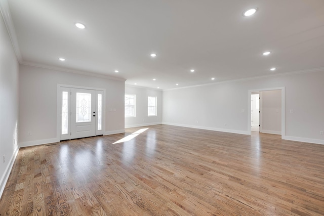 interior space with light wood-type flooring and ornamental molding