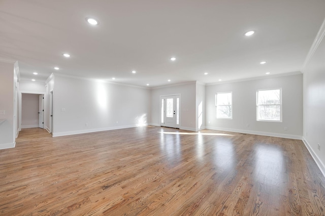 unfurnished living room with light wood-type flooring and crown molding