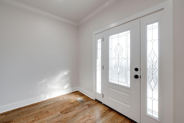 entrance foyer with crown molding and light hardwood / wood-style flooring