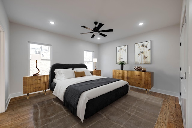 bedroom with ceiling fan and dark wood-type flooring