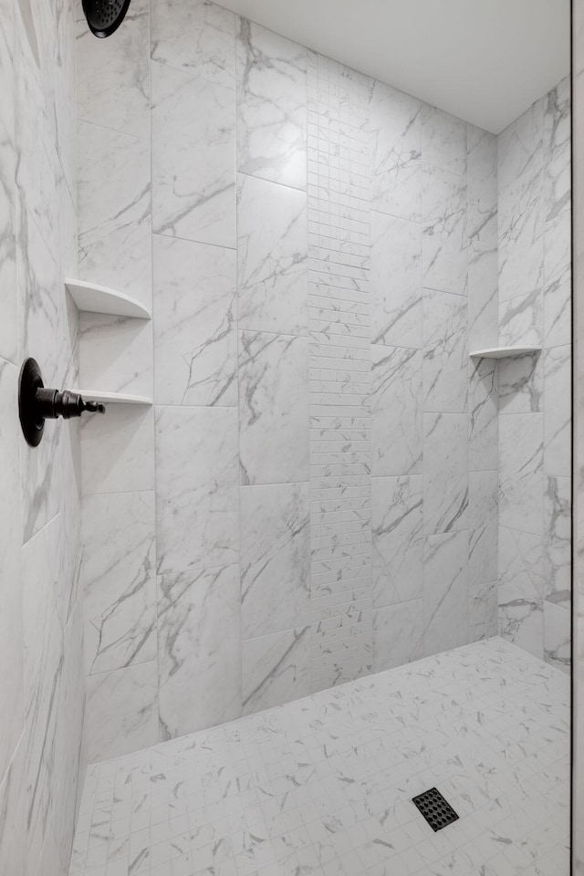 bathroom with tiled shower