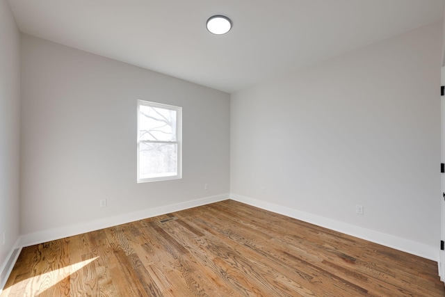 empty room with wood-type flooring