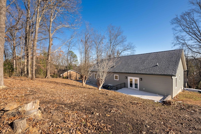 rear view of property with french doors and a patio