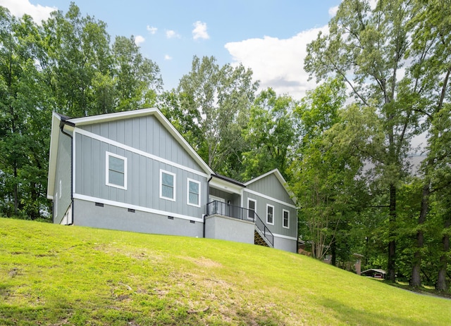 107 Douglas Dr, Chattanooga, TN 37412 - view of front of property featuring crawl space, board and batten siding, stairs, a front yard, and view of scattered trees