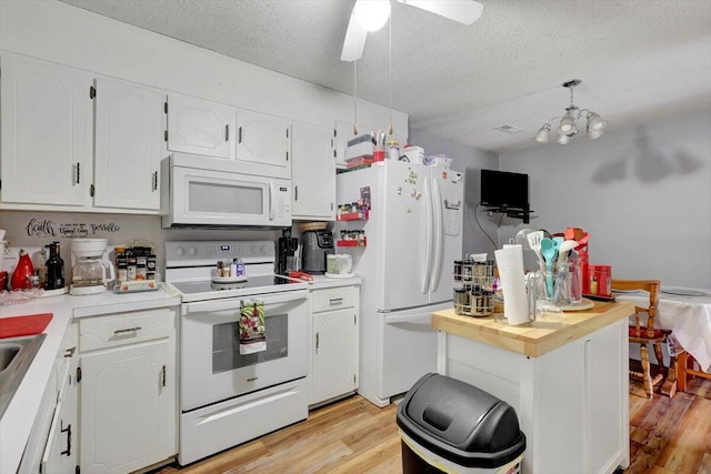 kitchen featuring white cabinetry, a textured ceiling, white appliances, and light hardwood / wood-style flooring