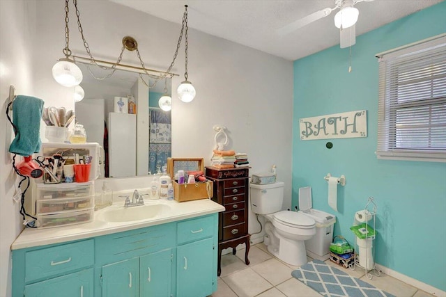 bathroom with tile patterned floors, toilet, a textured ceiling, vanity, and ceiling fan