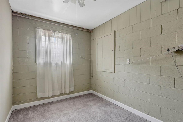 unfurnished room featuring brick wall, carpet flooring, and ceiling fan