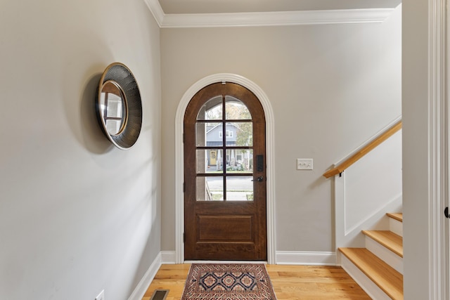 entryway featuring hardwood / wood-style flooring and crown molding