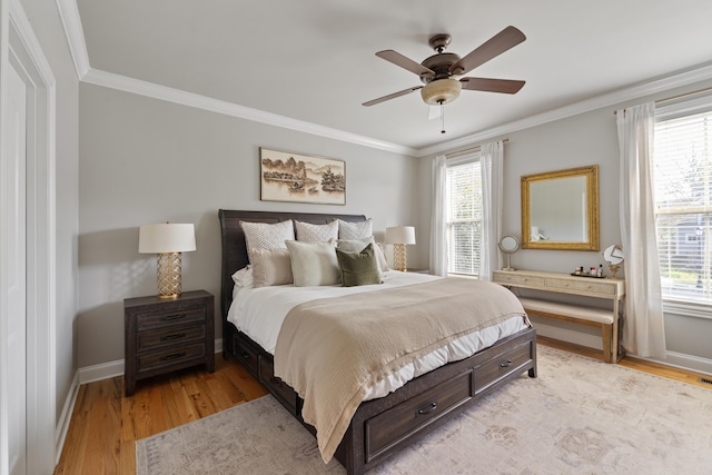 bedroom featuring ceiling fan, ornamental molding, and light wood-type flooring