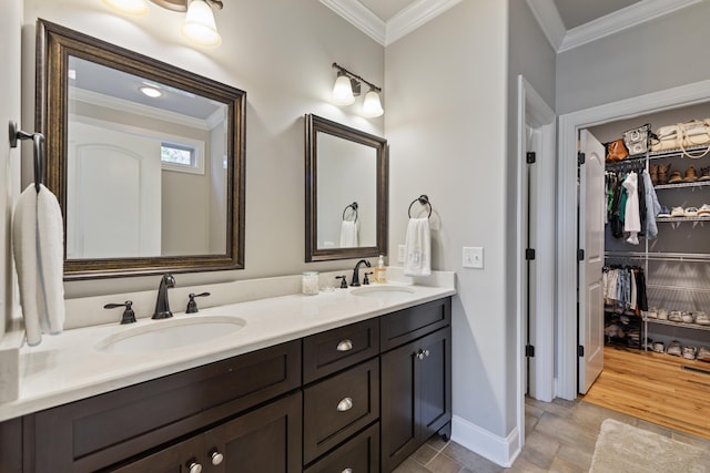 bathroom with ornamental molding and vanity