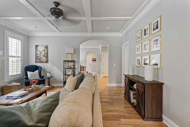 living room with beamed ceiling, light wood-type flooring, ceiling fan, crown molding, and coffered ceiling