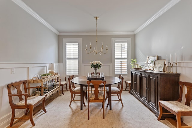 dining area featuring ornamental molding, a chandelier, and a healthy amount of sunlight